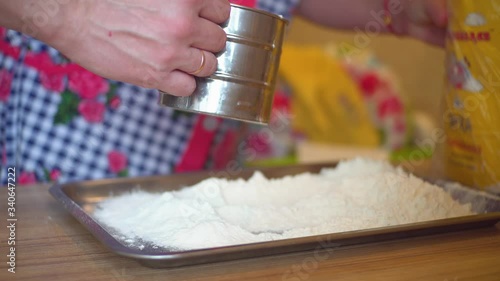 a close-up of a man sifting flour