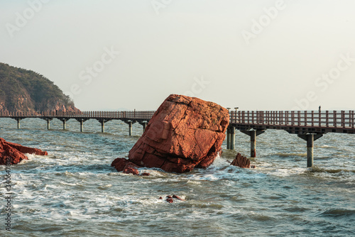 Wallpaper Mural Westbound rocky shore of with red rocks during high tide. Late afternoon view. Torontodigital.ca