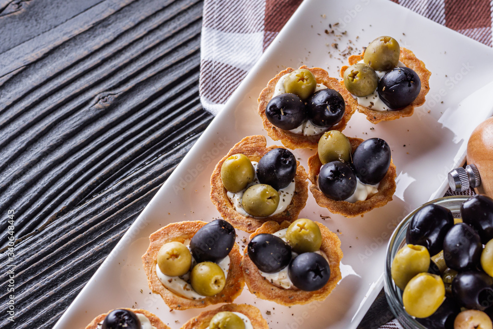 delicious snack tartlets on rustic wooden background delicious snack tartlets on rustic wooden background