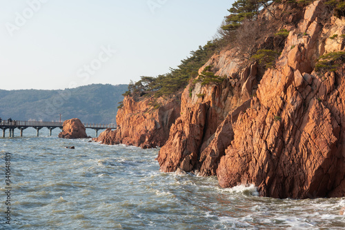 Wallpaper Mural Westbound rocky shore of with red rocks during high tide. Late afternoon view. Torontodigital.ca