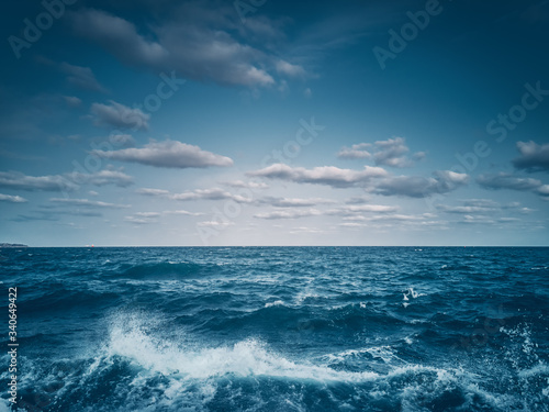 Waves amd sea ripple water with blue clody sky © ValentinValkov
