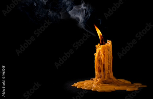 Fototapeta Naklejka Na Ścianę i Meble -  light flame candle burning brightly on black background