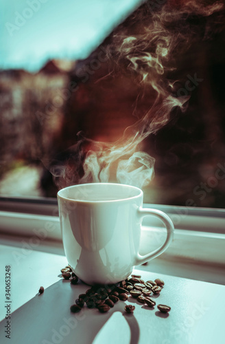 cup of coffee with cinnamon and beans