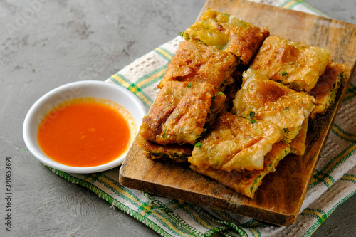 Martabak Telor or Martabak Telur. Savory pan-fried pastry stuffed with egg, meat and spices photo