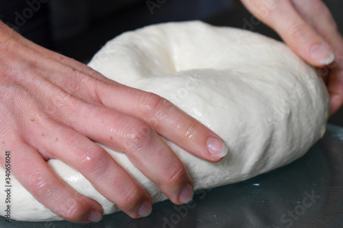 Close up of a womans hand kneading dough used for home baked bread