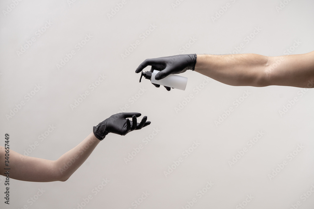 Hands in black silicone gloves on a light background. Hands in black silicone gloves on a light background.