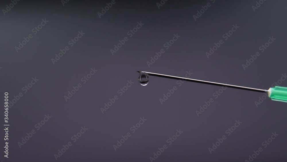 Medicine leaking from a syringe drop by drop. Medicine leaking from a syringe drop by drop.