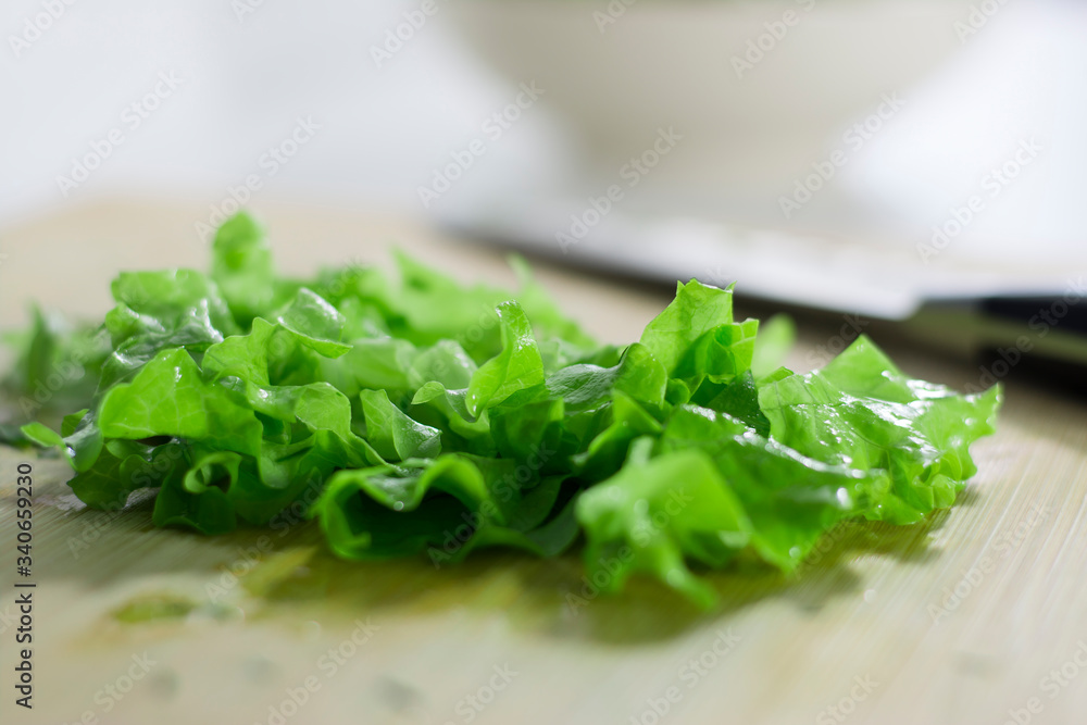 Fresh green lettuce sliced on a cutting board. Healthy eating Fresh green lettuce sliced on a cutting board. Healthy eating