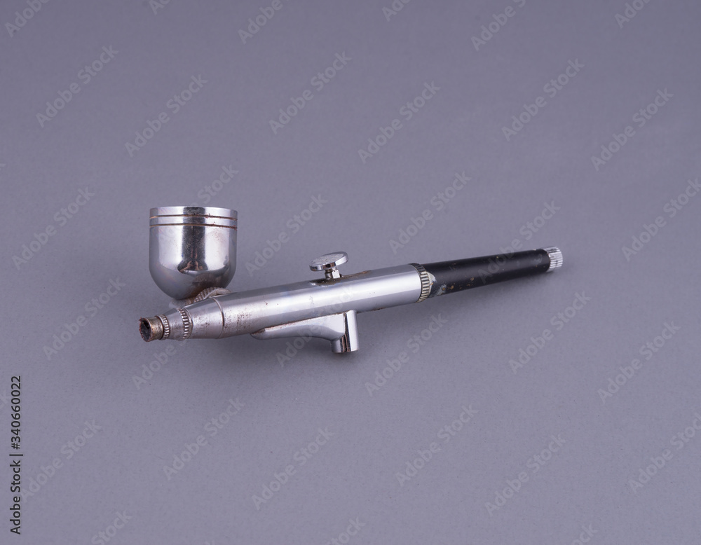 Old air brush on a gray background Old air brush on a gray background