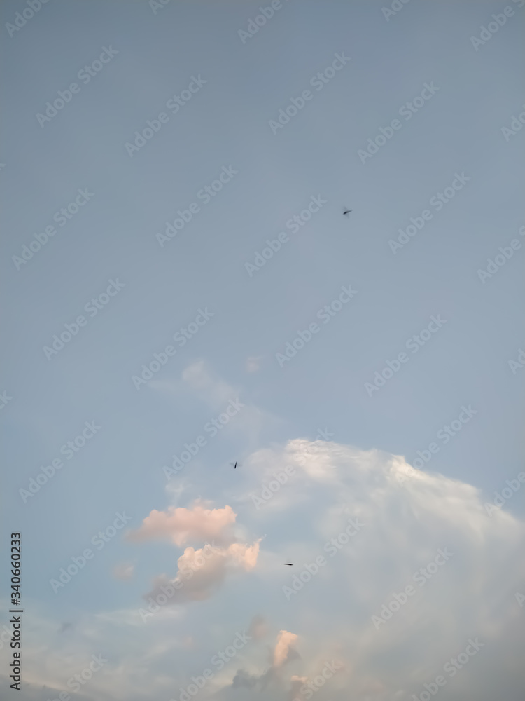 Fototapeta premium Natural cloud fly blue sky landscape and sun rising at skyline.
