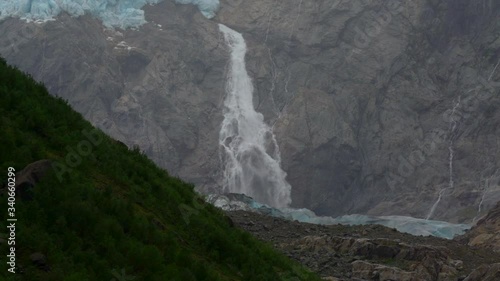 Buerbreen glacier with a waterfall in norway