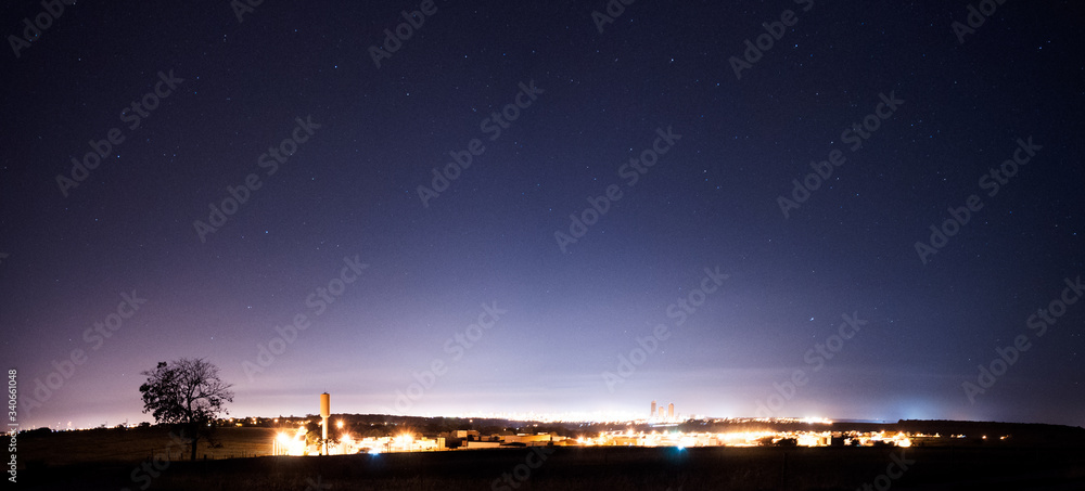 Panoramic view of Bauru in the night with some city lights and stars