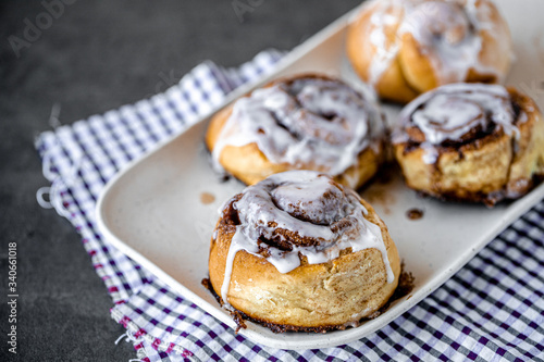 Fresh Homemade Cinnamon Rolls made on a plate with a napkin for breakfast