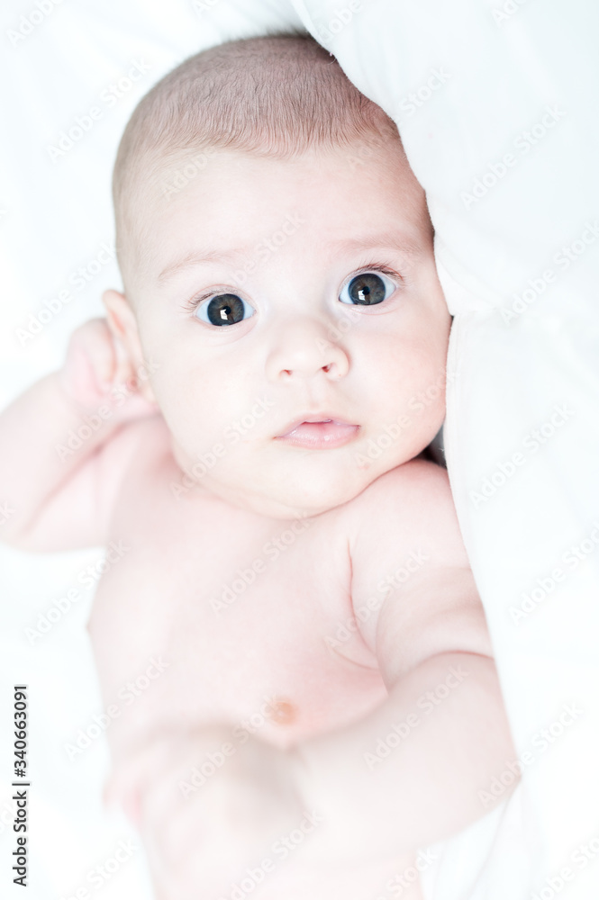 Close up newborn baby. First minutes of life. Newborn baby wrapped in the bedsheet of the hospital Close up newborn baby. First minutes of life. Newborn baby wrapped in the bedsheet of the hospital