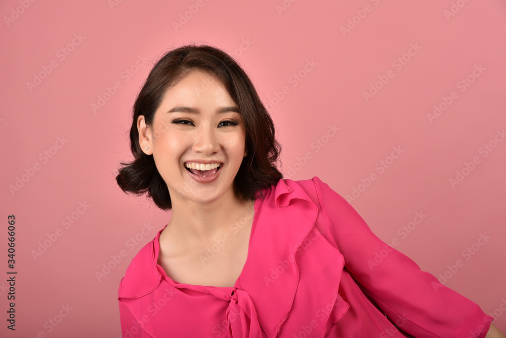 Asian woman relaxing on pink background, Portrait of happy smiling middle age woman in casual clothes looking at the camera. Asian woman relaxing on pink background, Portrait of happy smiling middle age woman in casual clothes looking at the camera.