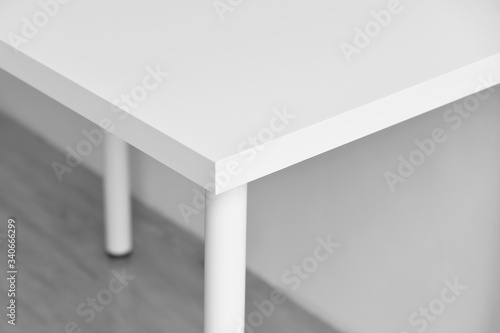 Obraz na płótnie Table corner, Sharp desk edge, Home accident from furniture, White table with hard angle, Minimal style and copyspcae for wording. w salonie