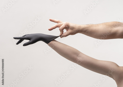 Female hand in a black silicone glove