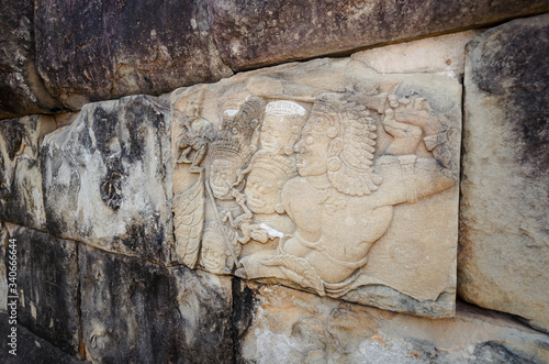 Detail of bas relief carving of warrior in Hindu mythology, on Wat Bakong ancient temple in Angkor Wat, Siem Reap, Cambodia photo