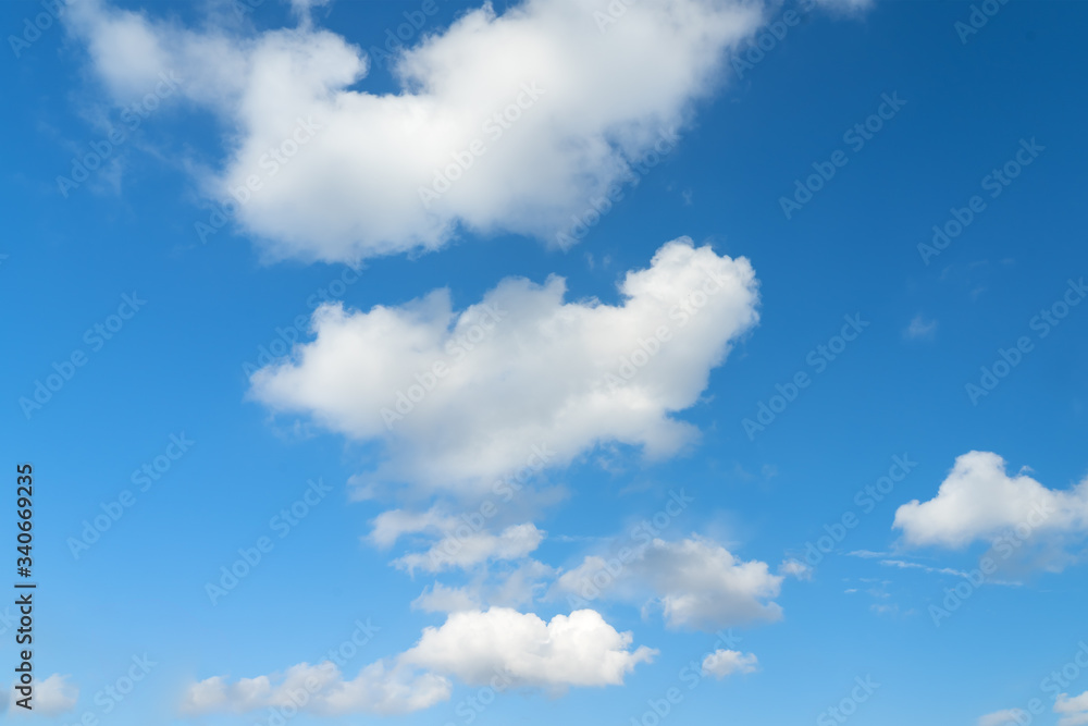 Fototapeta premium Large white clouds on a blue sky. Clear day. Background, blank for designers.