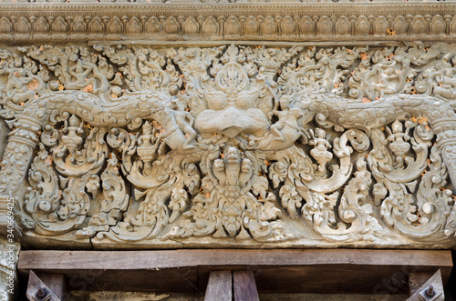 Garuda head and demon carvings on a lintel in Lolei ancient Hindu temple, Angkor Wat, Siem Reap, Cambodia photo