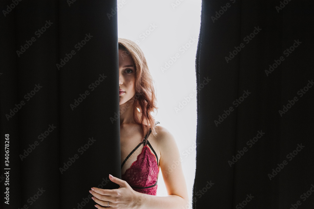 Beautiful young woman in underwear near the window. Beautiful young woman in underwear near the window.
