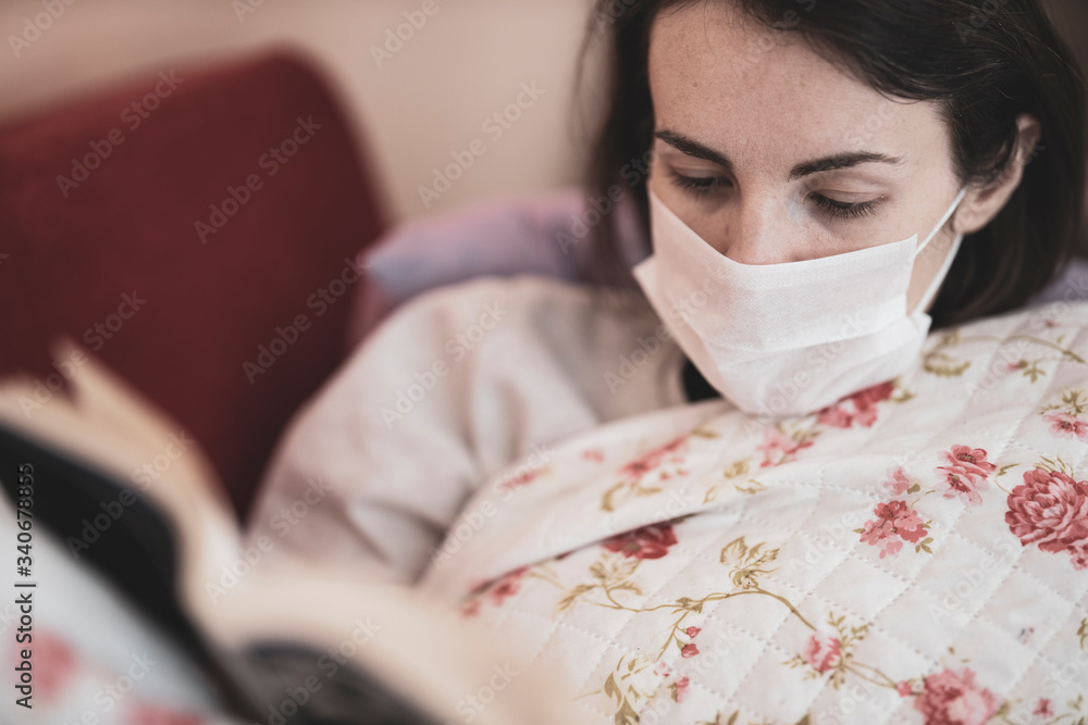 girl reading a book in her home during the coronavirus outbreak girl reading a book in her home during the coronavirus outbreak