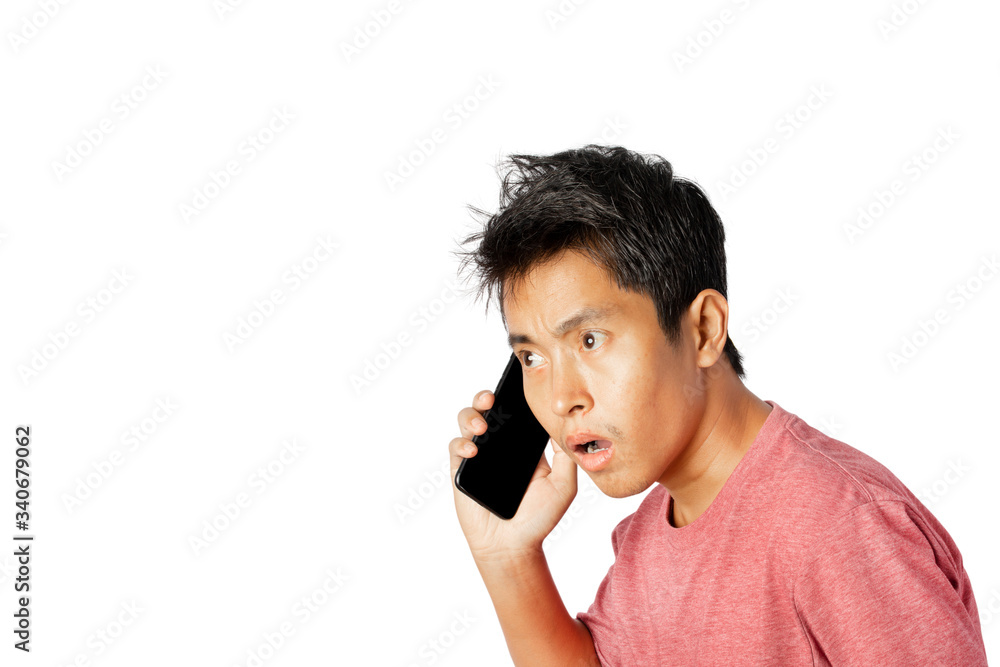 Young man talking on the phone, shocked with and surprise face on white background. Young man talking on the phone, shocked with and surprise face on white background.