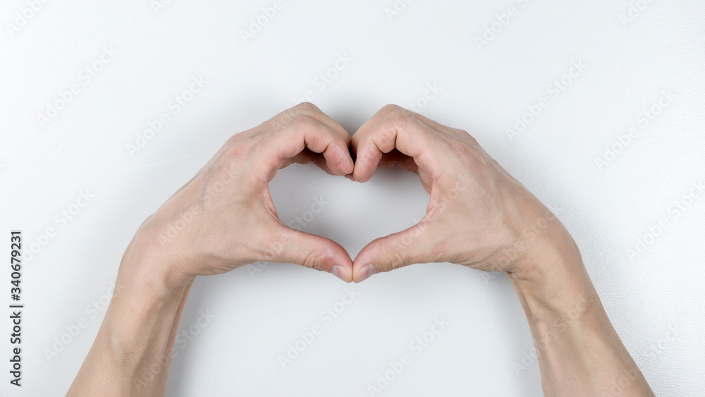 Fototapeta premium hands forming a heart on white background