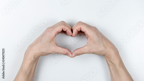 hands forming a heart on white background