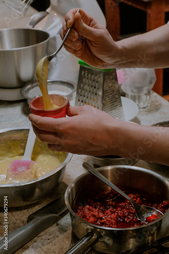 The process of making pancakes with raspberries