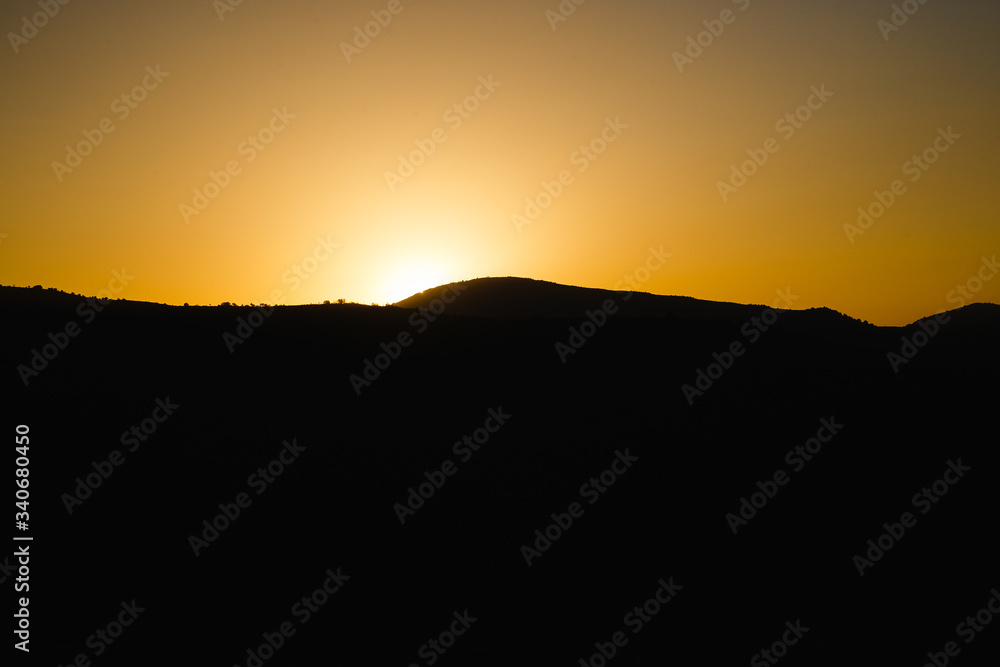 mountain silhoette of austrian alps at sunrise glowing sky mountain silhoette of austrian alps at sunrise glowing sky