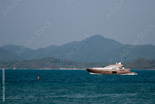 A speed boat cuts through the water of the Gulf of Thailand