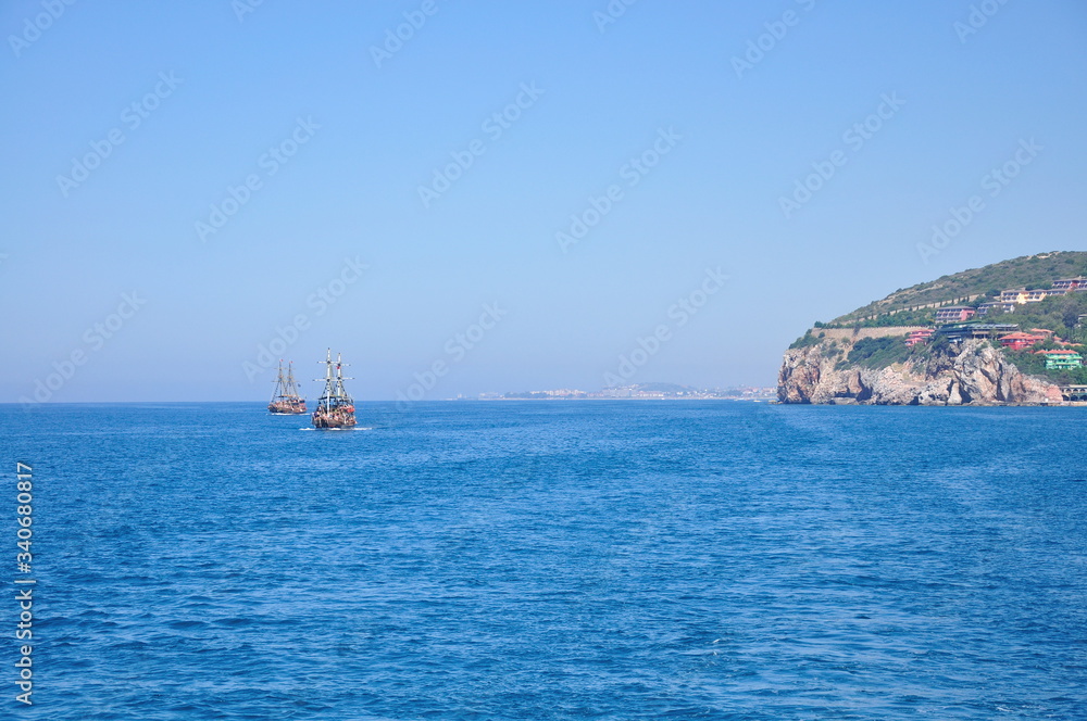 Romantic sea landscape with distant ships and pure blue sky.