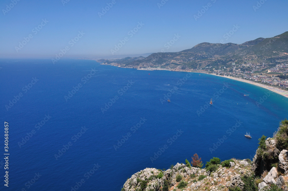 Beautiful sea views and ships from the high mountain. On the horizon, the sea merges with the sky.