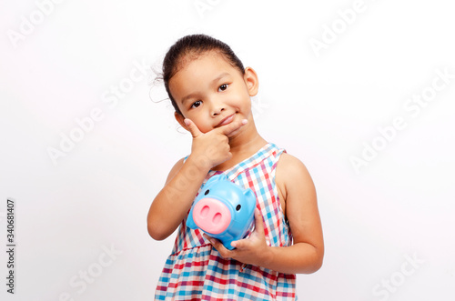 Cute Asian baby girl portrait hand holding piggy bank for saving money on white backgrounds
