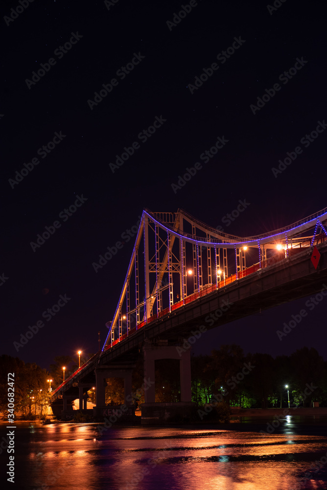 Night view of pedestrian bridge on Dnipro in Kiev Ukraine