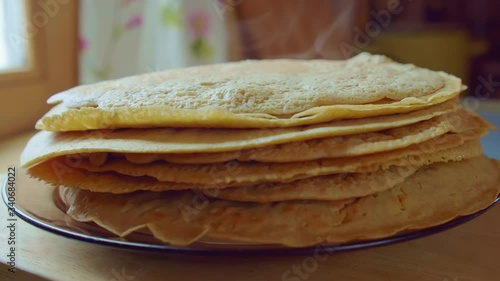Chef cook put by spatula the steam yummy pancake on stack plate. Slowmo closeup