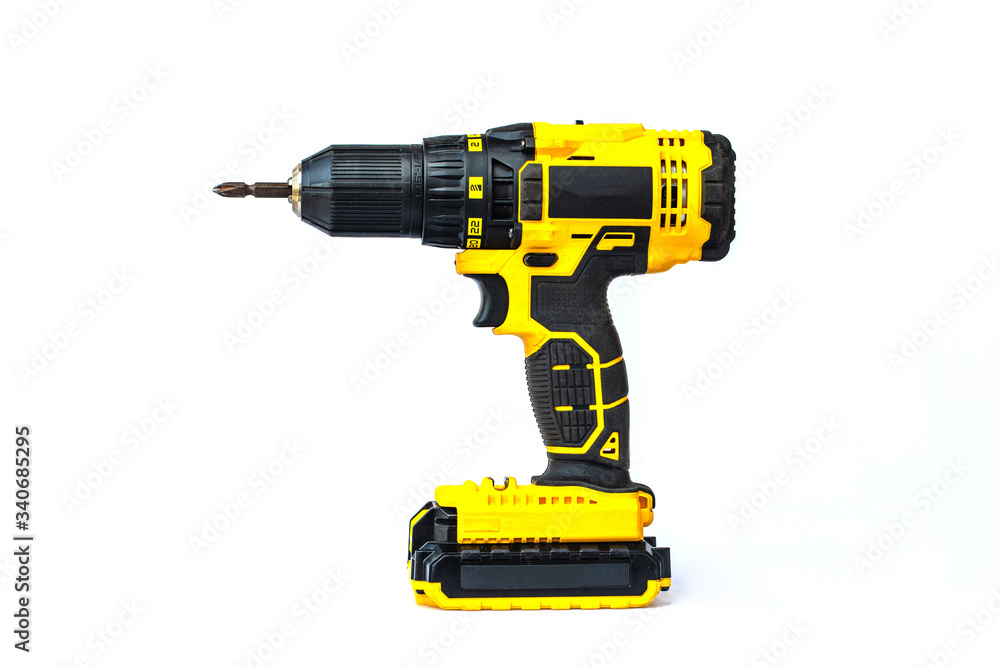The yellow cordless battery powered drill isolated on white background. The yellow cordless battery powered drill isolated on white background.