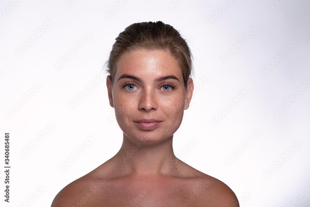 Beautiful girl with freckles shows emotions in front of the camera on a white background Beautiful girl with freckles shows emotions in front of the camera on a white background