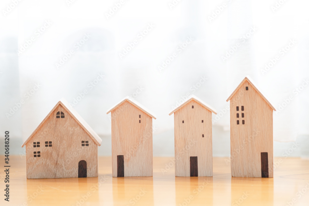 wood house model or apartment building. different properties on the background. owner or agent planning to sell or buy real estate concept wood house model or apartment building. different properties on the background. owner or agent planning to sell or buy real estate concept