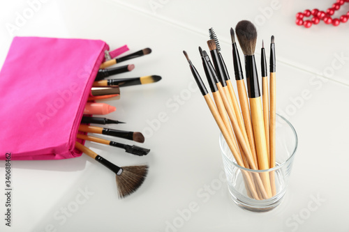 background with makeup brushes. make-up brushes in a glass