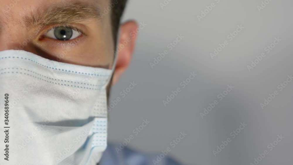 men in donning a mask from Covid-19. White protective mask against the virus. Close-up men in donning a mask from Covid-19. White protective mask against the virus. Close-up