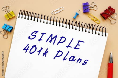 The caption in the picture is SIMPLE 401k Plans. Notebook sheet, table, pens.