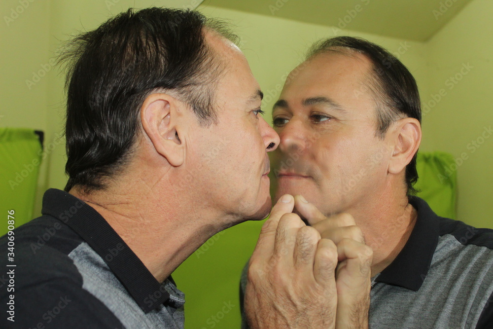 Man kissing a mirror Man kissing a mirror