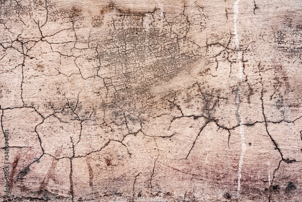 Texture of a concrete wall with cracks and scratches which can be used as a background Texture of a concrete wall with cracks and scratches which can be used as a background