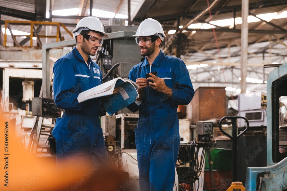 Group of industrial factory maintenance engineers inspect relay protection system using walkie talkie with copy space for your text. Industry, Maintenance, Engineering and construction concept. Group of industrial factory maintenance engineers inspect relay protection system using walkie talkie with copy space for your text. Industry, Maintenance, Engineering and construction concept.