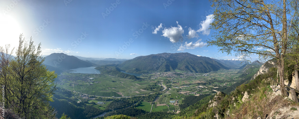 Picturesque mountain landscape of a panorama of Trento, Italy, lake, huge valley, sunny weather, clouds