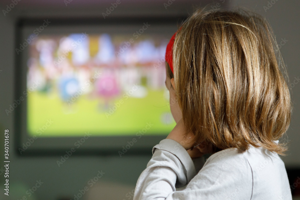Little girl watching cartoons at home Little girl watching cartoons at home