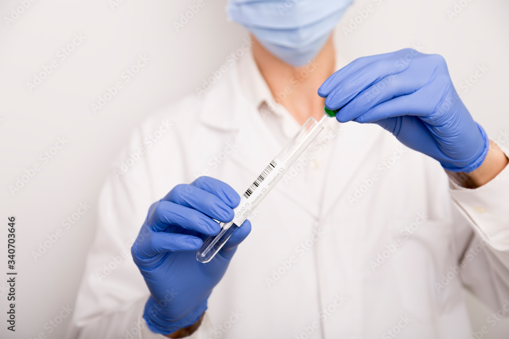 Covid test in the hands of a male doctor with blue gloves Covid test in the hands of a male doctor with blue gloves