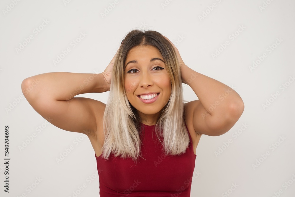 Excited overjoyed woman screams after recieving good news, keeps hands on head, can't believe it. Excited overjoyed woman screams after recieving good news, keeps hands on head, can't believe it.